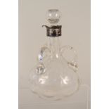 A mid 19th Century three handled decanter with silver neck ring