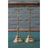 A large pair of 19th Century brass door stops with loop handles,