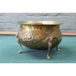 A 19th Century fruit embossed oval brass jardiniere or wine cooler raised on four legs with paw