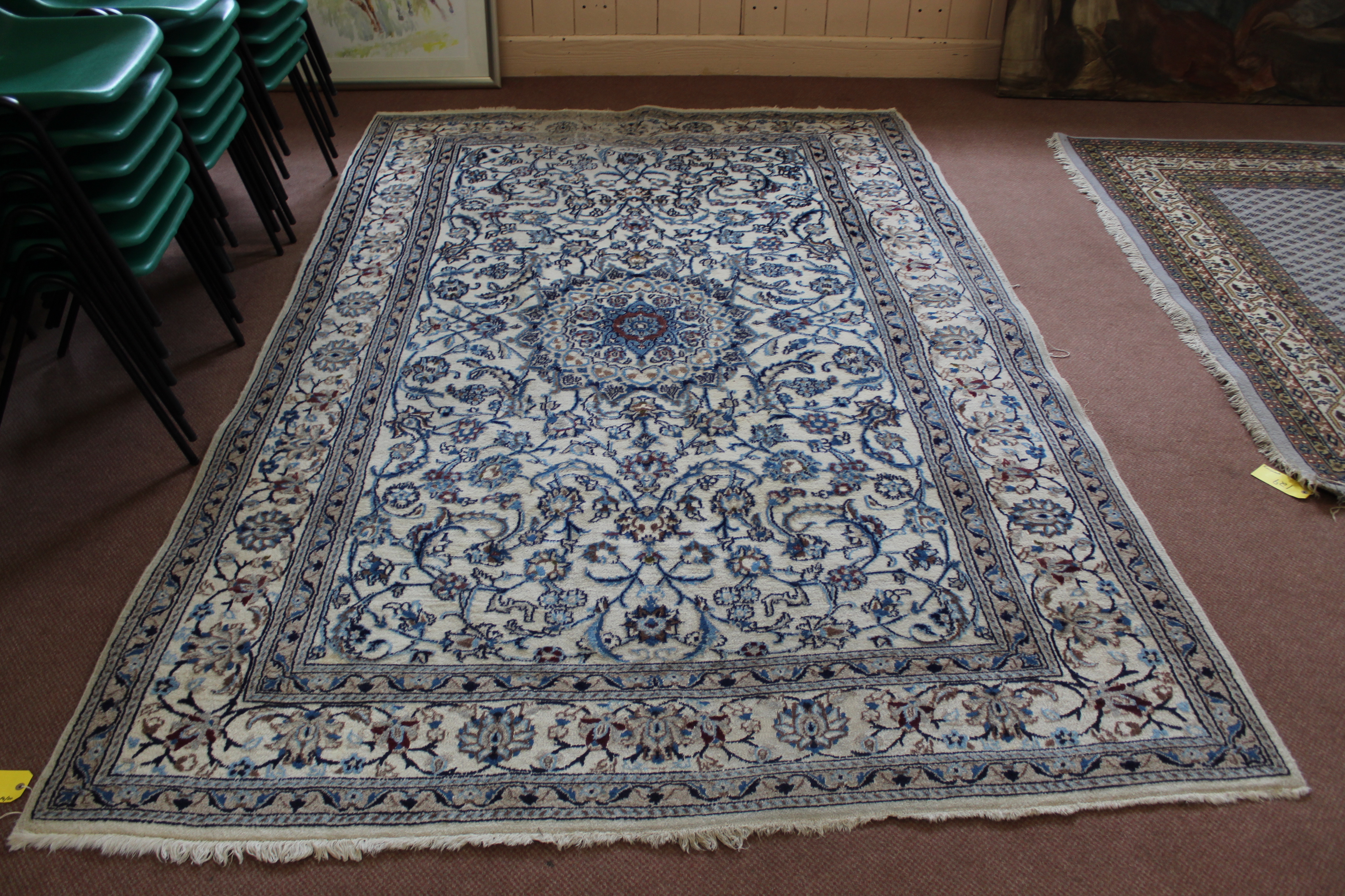 A large cream wool rug,