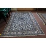 A large cream wool rug,