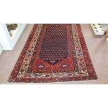 A red and cream ground rug,