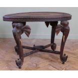 A late 19th Century padouk wood oval Indian centre table on elephant legs with bone tusks