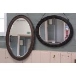 Two early 20th Century oval veneered wall mirrors