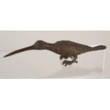 A miniature bronze of a long billed bird,
