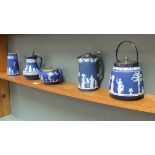 Five items of Wedgwood blue Jasper ware including biscuit barrel and two water jugs with plated