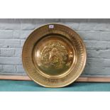 A large Arts and Crafts brass alms dish,