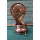 A hanging circular copper jardiniere with brass tap and large back plate embossed with fox, bird,