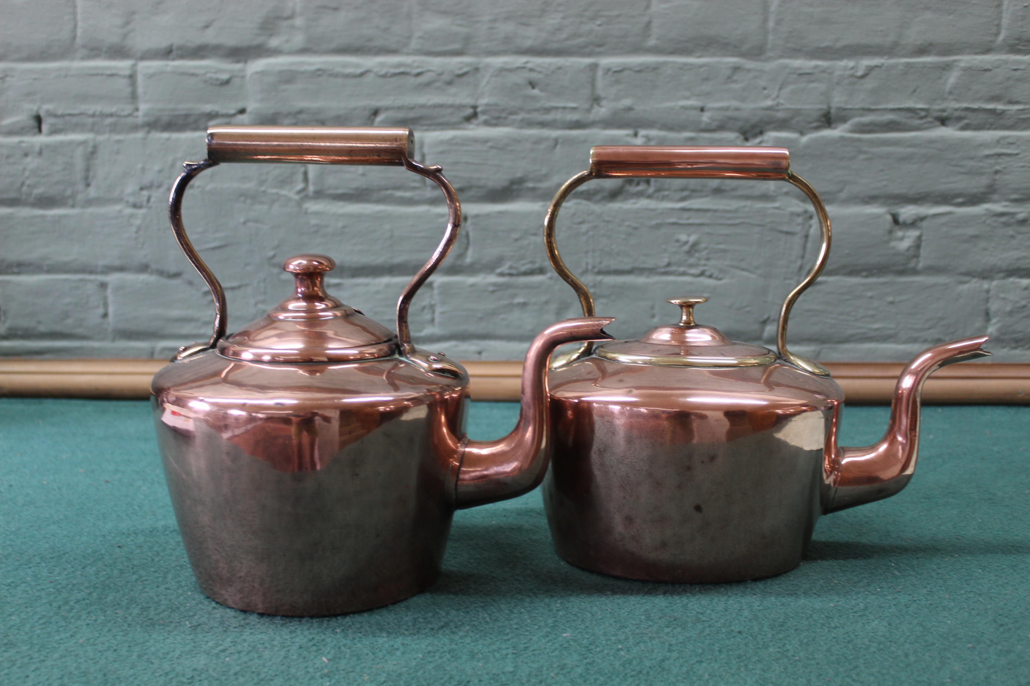 Two Victorian seamed copper kettles, one circular with hinged lid and the other oval,