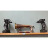A pair of cast metal greyhound bookends plus a brass and copper bugle