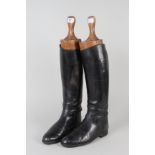 A pair of hunting boots with wooden lasts
