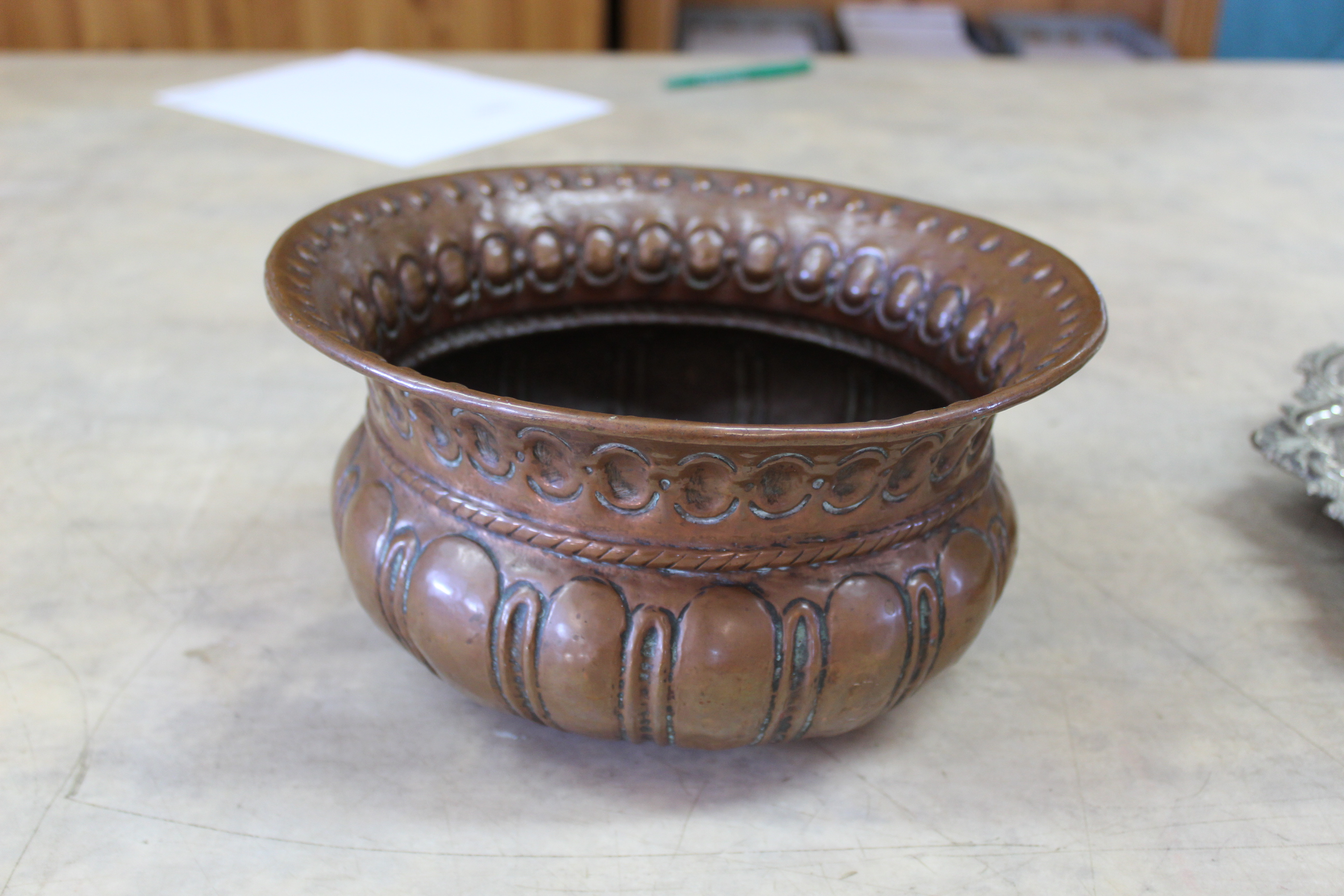 An 18th Century circular copper jardiniere or wine cooler with gadrooned and punched decoration,