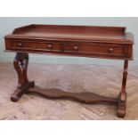 A mid 19th Century writing table on 'lyre' ends and shaped stretcher