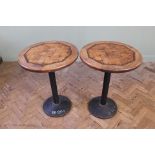 A pair of cafe tables, the round parquetry inlaid tops on circular iron bases,
