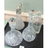 Three various cut glass decanters with a silver plate claret jug