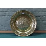 A 19th Century embossed brass alms dish with script and date of 1503,