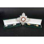 A silver mounted block in the form of the KBE Breast Star commemorating the 75th anniversary of the