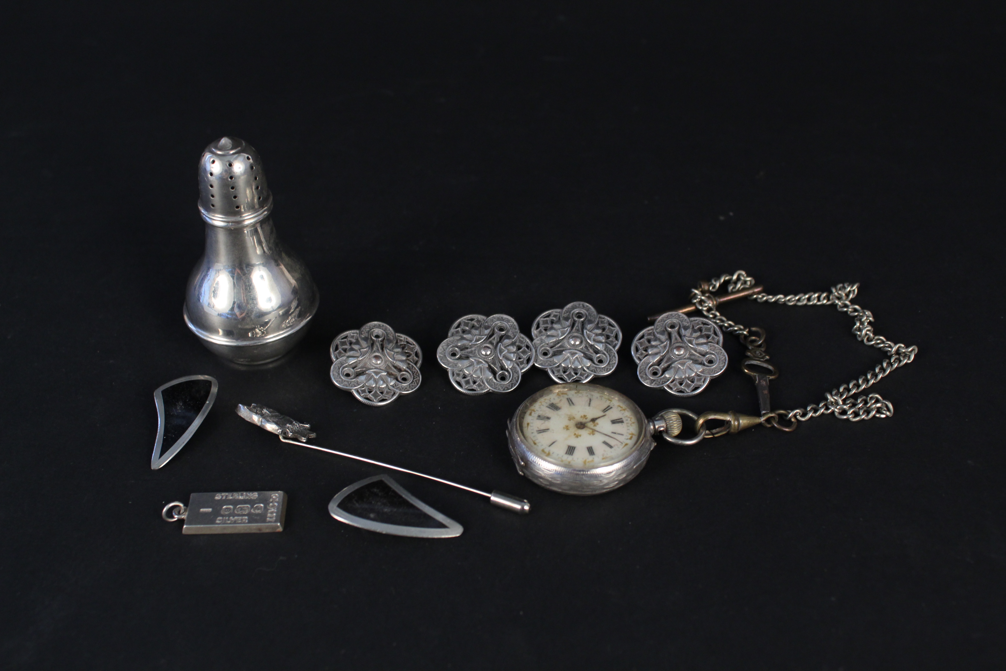 A small collection of silver and white metal items including a pair of J Jensen Danish earrings