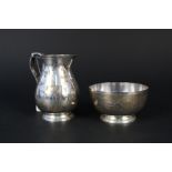 A silver cream jug on flared base, London 1975 by Richard Comyns with matching sugar bowl,