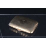 A 9ct gold cigarette case with engine turned decoration, engraved name to centre (heavily dented),