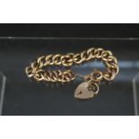 A 9ct gold curb link bracelet with heart shaped padlock clasp, approx 20.