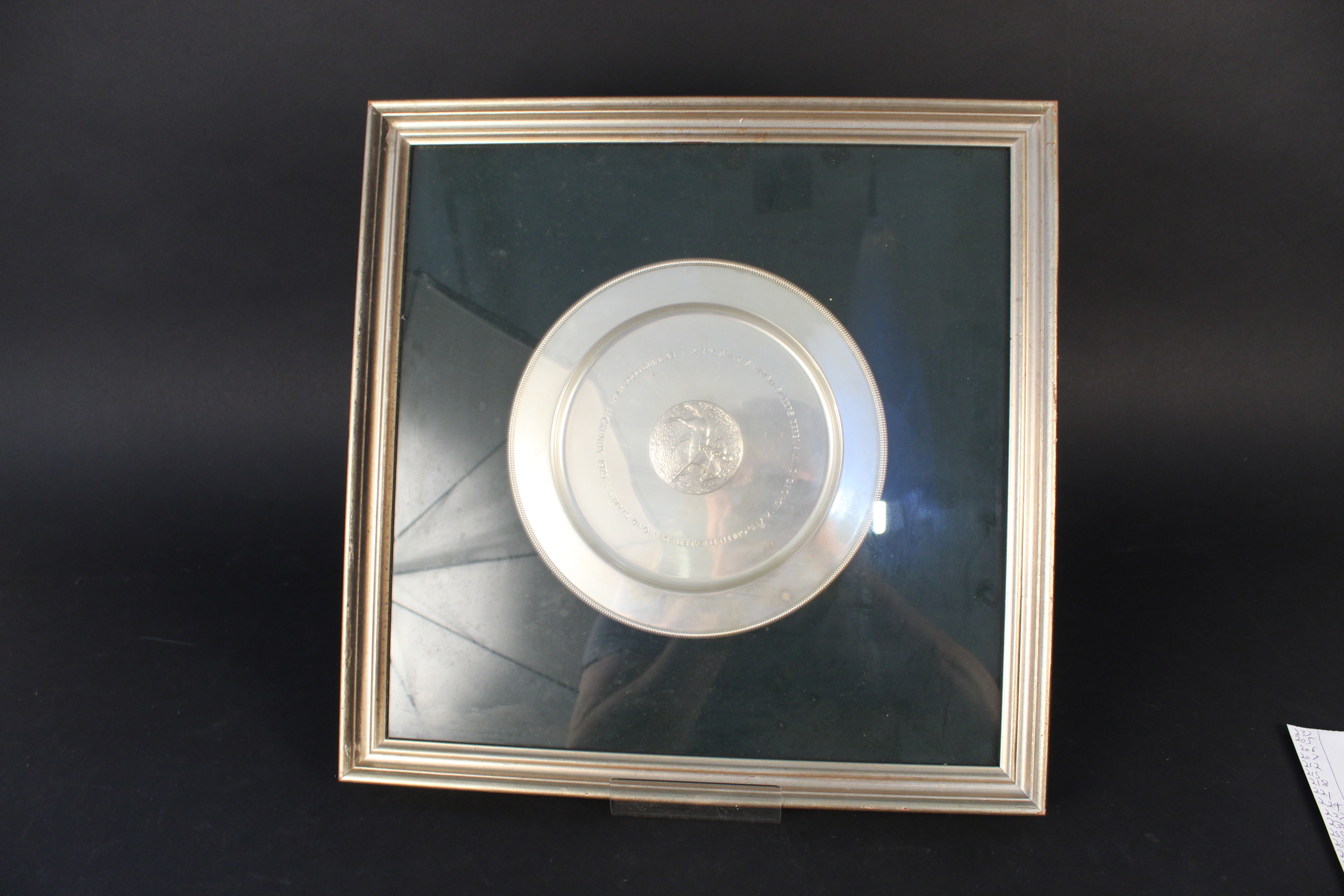 A framed silver dish with horse racing scene to centre entitled ''Grundy 1975''