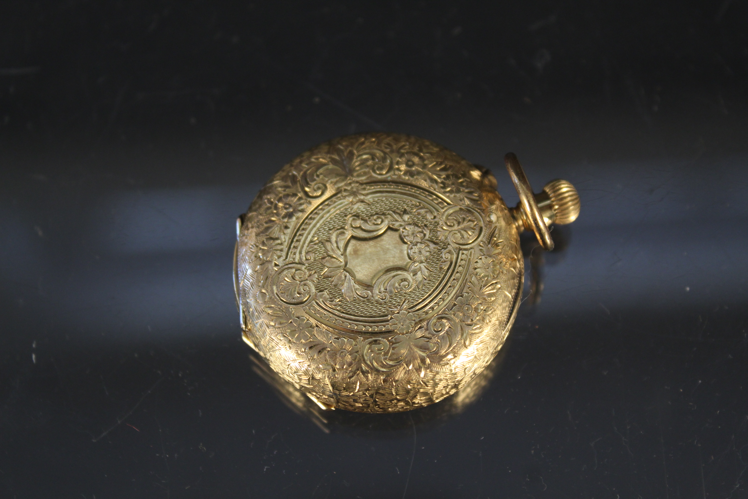 A 14ct gold continental fob watch with foliate decoration (metal dust cover) - Image 2 of 3