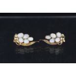 A pair of yellow metal floral spray earrings, each set with five oval opal stones,