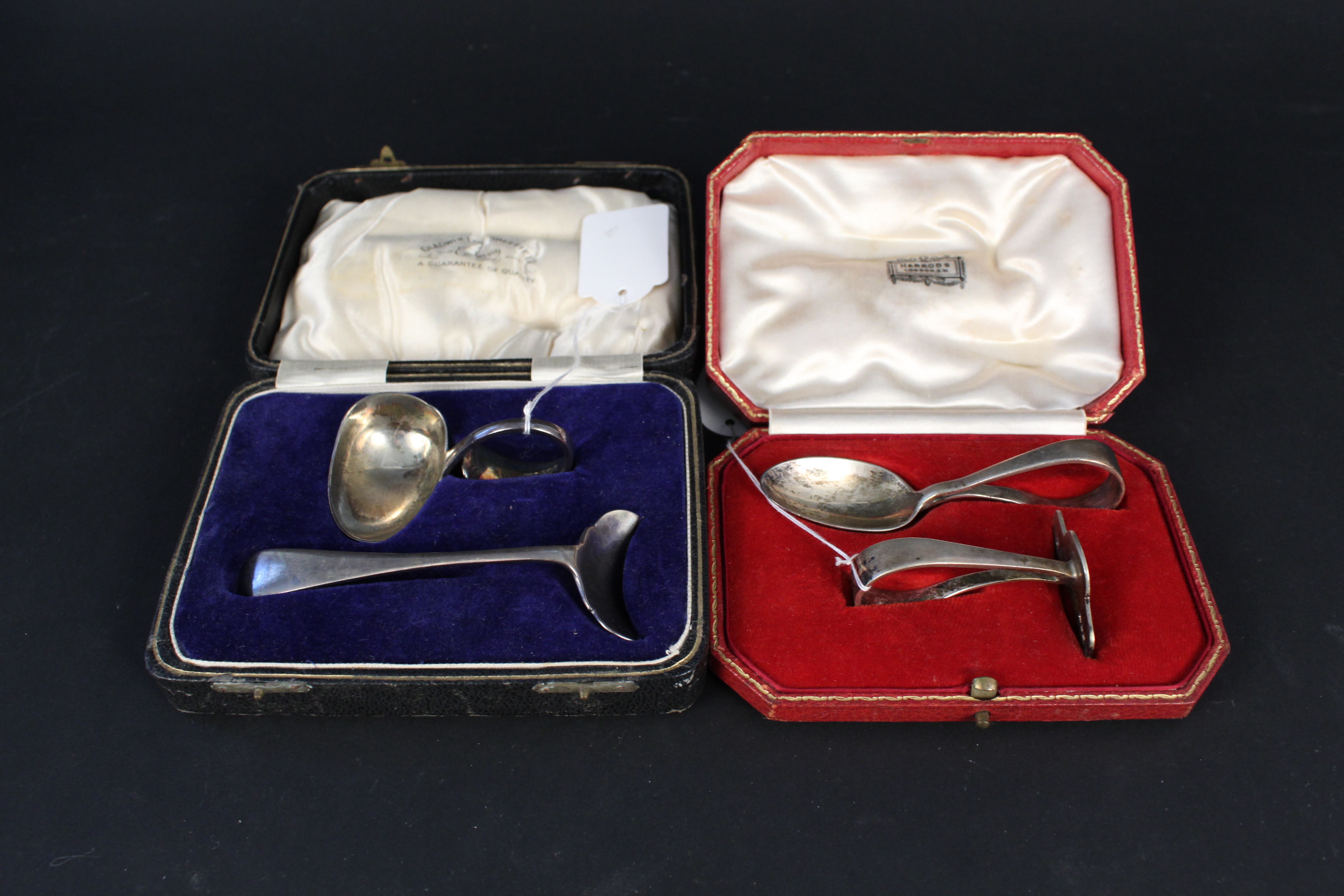 Two cased silver child's feeding sets (pusher and spoon), one by Harrods, London 1933,