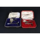 Two cased silver child's feeding sets (pusher and spoon), one by Harrods, London 1933,