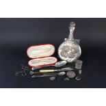 A wicker basket with mixed silver and silver plated items including hand mirror,