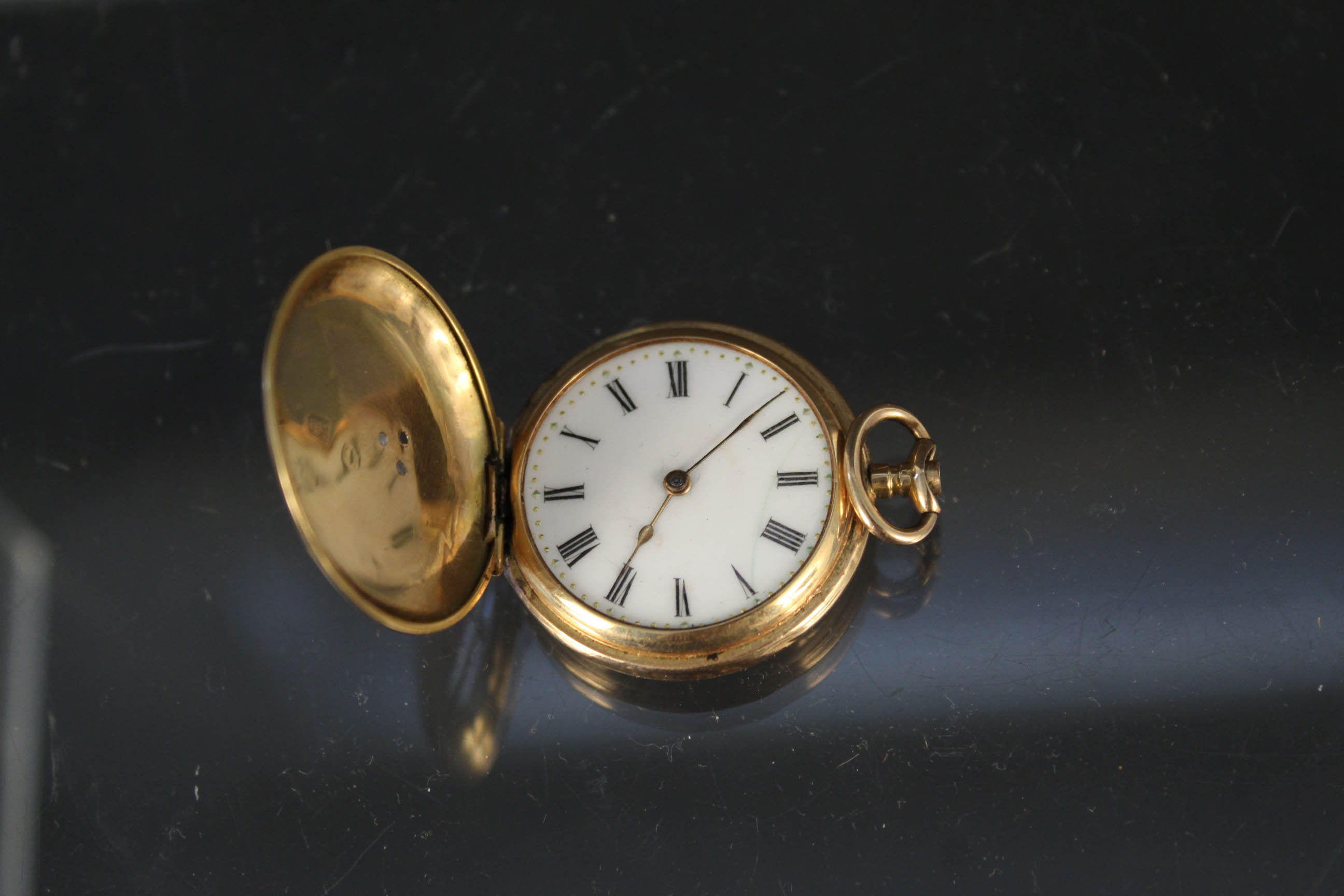 A continental 18ct gold cased hunter fob watch with enamel decoration to front (two of three rough