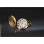 A continental 18ct gold cased hunter fob watch with enamel decoration to front (two of three rough