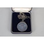 A silver 'pillar' 8 reales dated 1736 in silver mount with a chain,