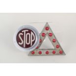 A stop light bezel and lens plus a vintage warning triangle