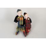 Two German porcelain dolls in Scottish outfits (one missing arms)