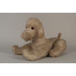 A 20th Century soft toy poodle with movable legs