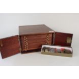 An oak cased coin collectors cabinet with fourteen trays,