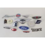 A quantity of assorted car badges including Jaguar