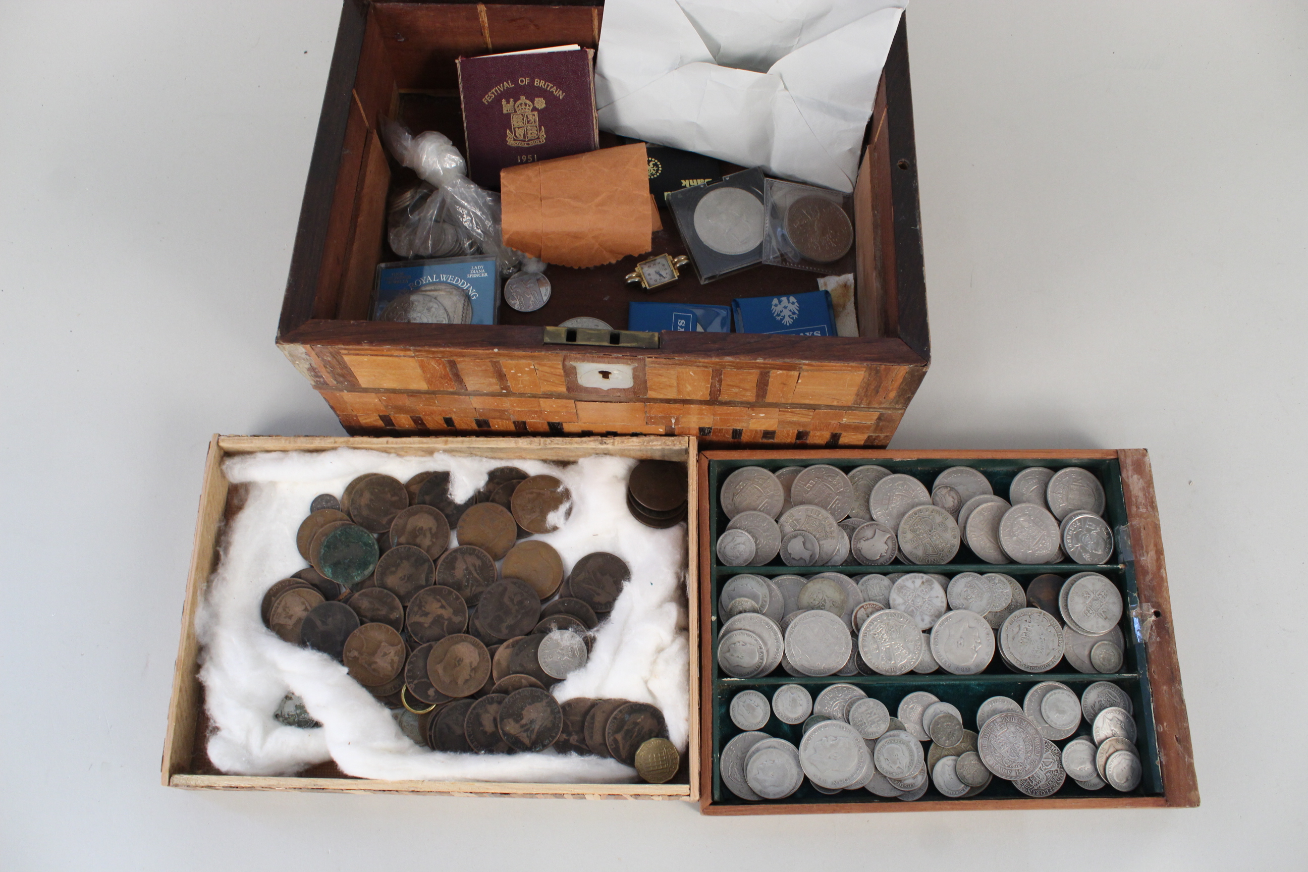 A box containing various coins including many 0.500 silver and 0.