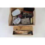 A box of various vintage car parts and tools