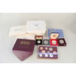 Nine Royal Mint proof sets in folders of issue,