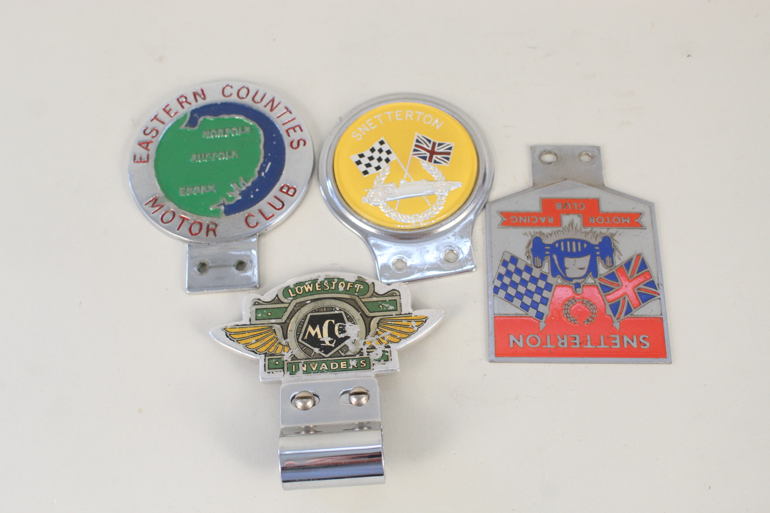 Four East of England Car Club badges including 'Snetterton'