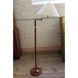 A brass and faux wood metal stem standard lamp