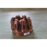 A Victorian oval copper jelly mould of fluted turret form by Benham & Froud No.