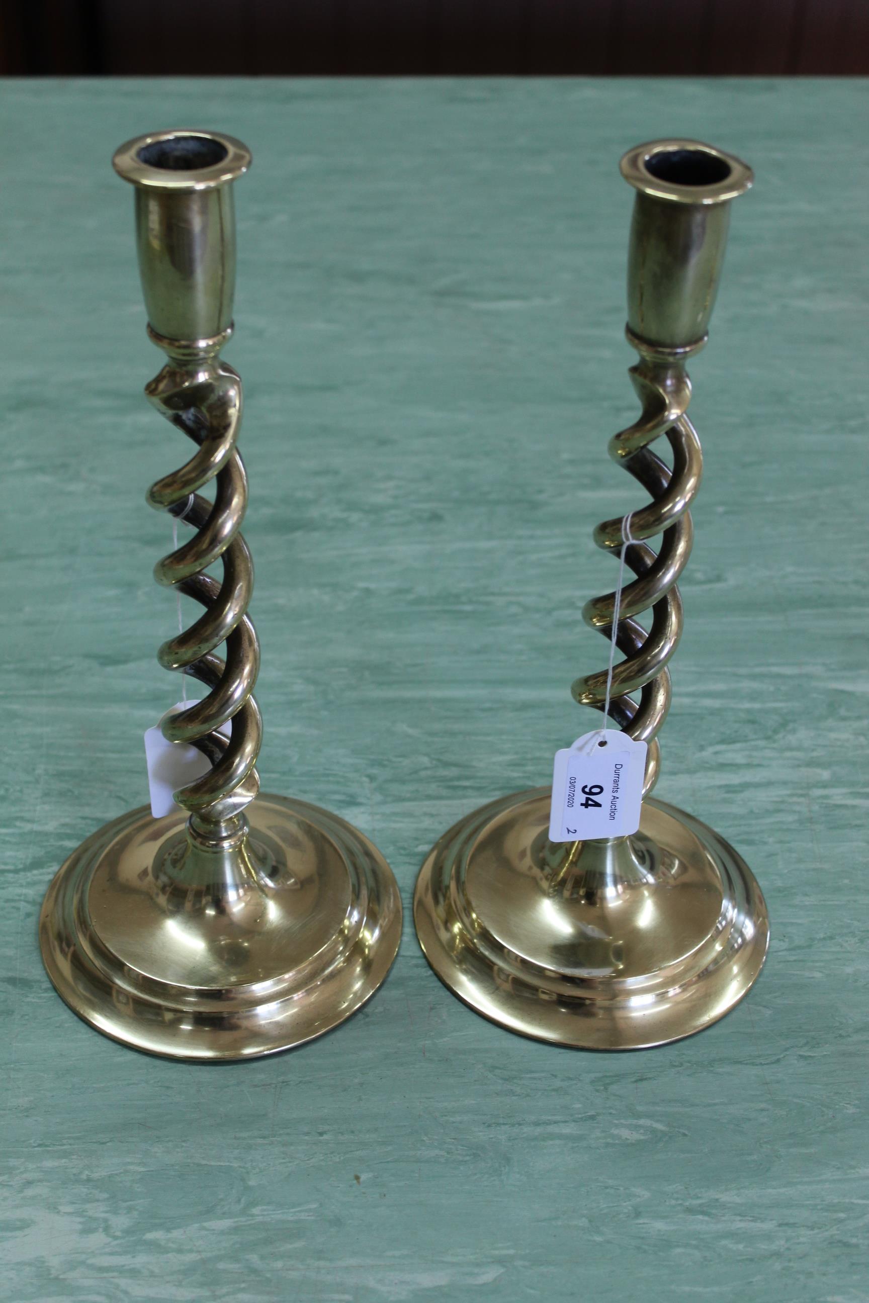 A pair of Edwardian open barleytwist brass candlesticks on circular bases 12" high
