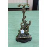 A Victorian brass and iron door stop depicting a stag in naturalistic setting,