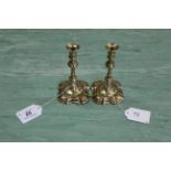 A pair of 18th Century style small brass candlesticks or tapersticks with multi knopped stems and