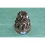 A large Victorian circular copper jelly mould of two tier swirled turret form, stamped '249',