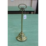 A 19th Century rope decorated brass door stop with tied loop handle and half bell shape weighted